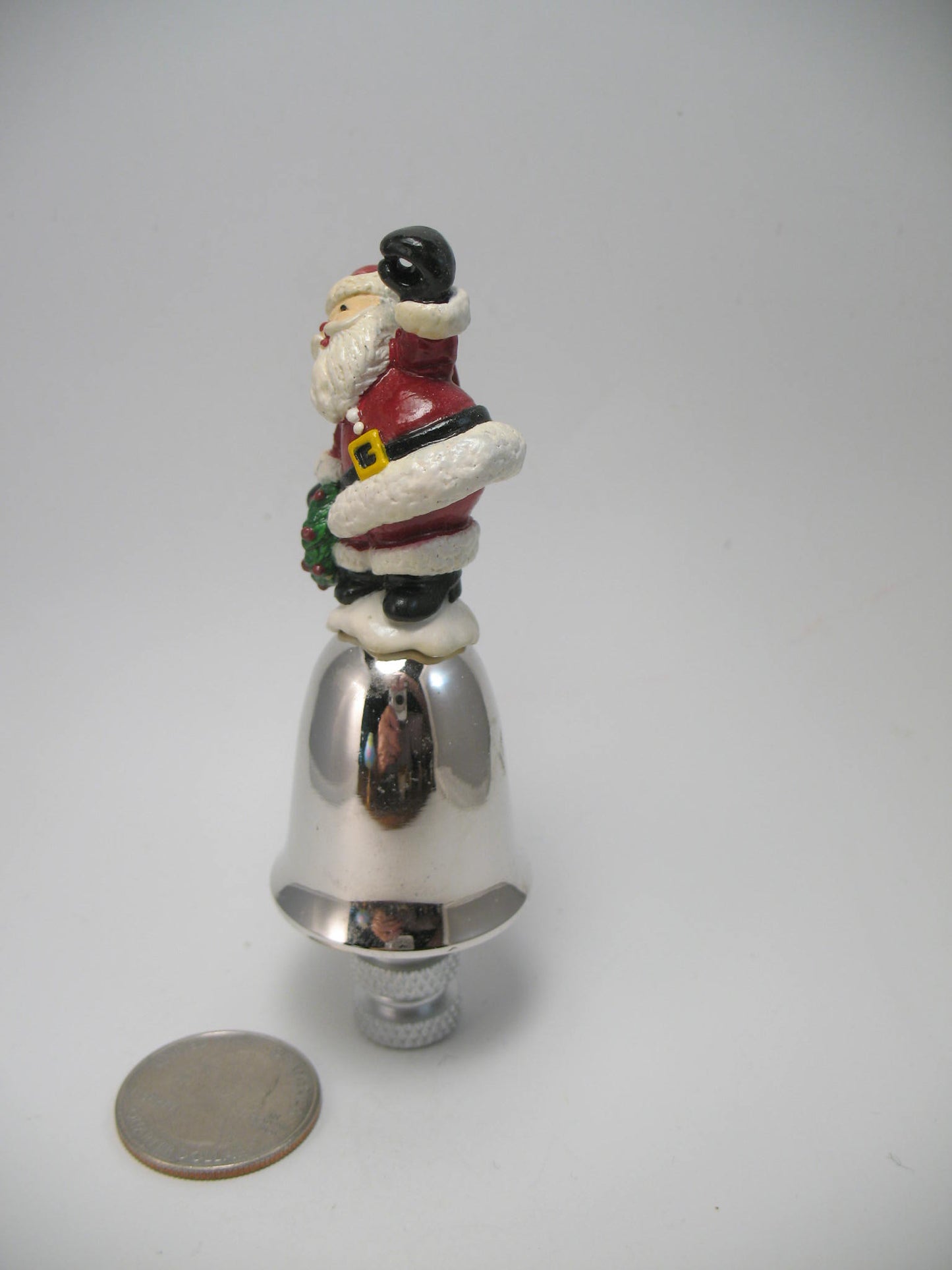 Santa Sitting on a Small Bell