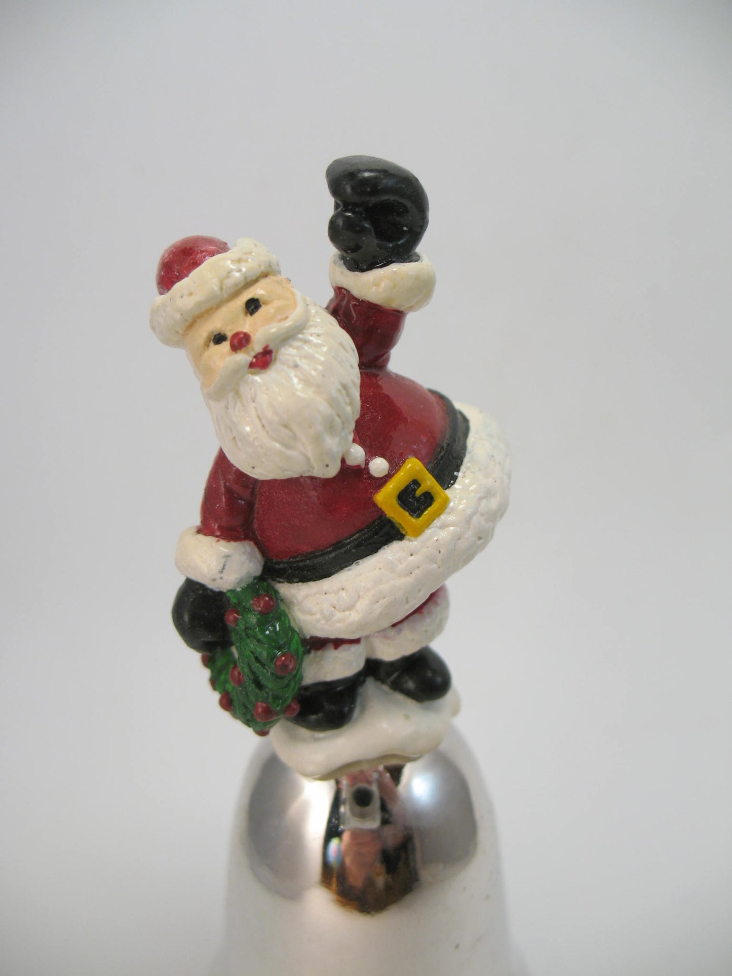 Santa Sitting on a Small Bell